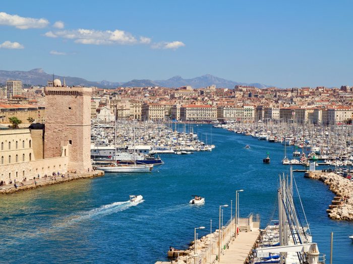 Vue panoramique du Vieux-Port de Marseille avec ses voiliers, ses bâtiments historiques et le Fort Saint-Jean.